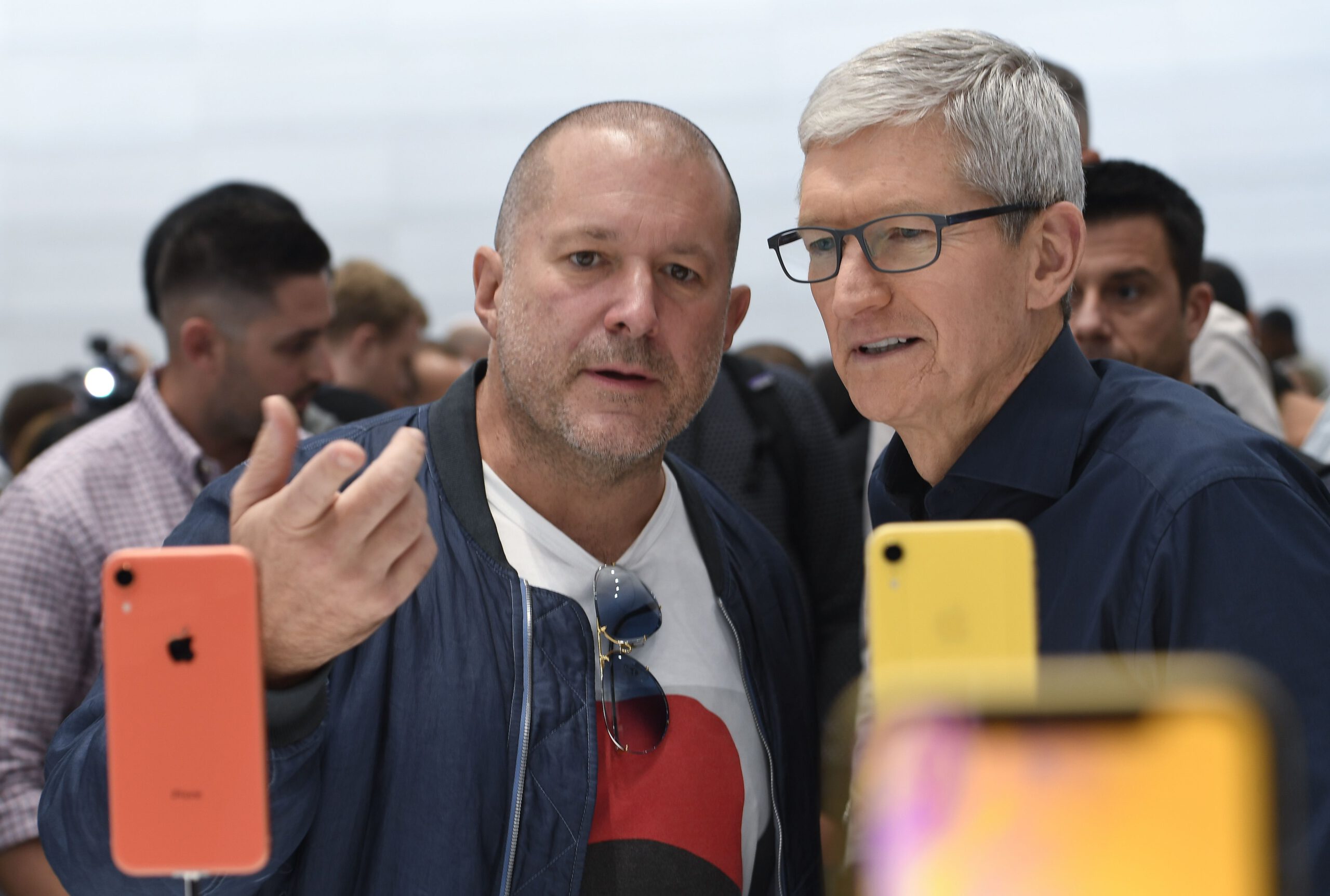 Apple chief design officer Jony Ive and Apple CEO Tim Cook inspect iPhone XR.